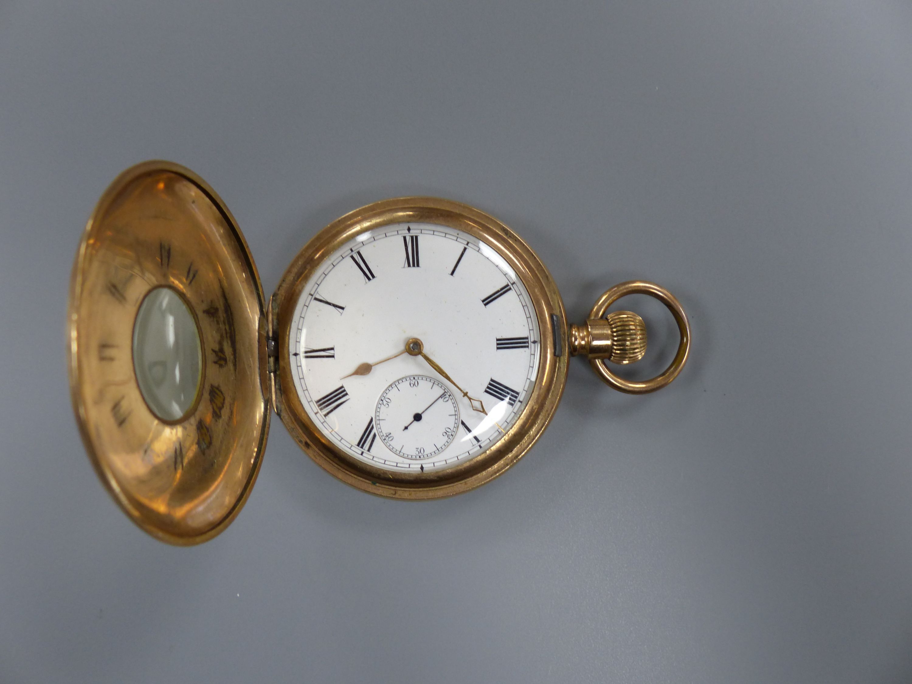 A gold plated half hunter pocket watch and a 375 and cultured pearl set tie pin, 55mm.